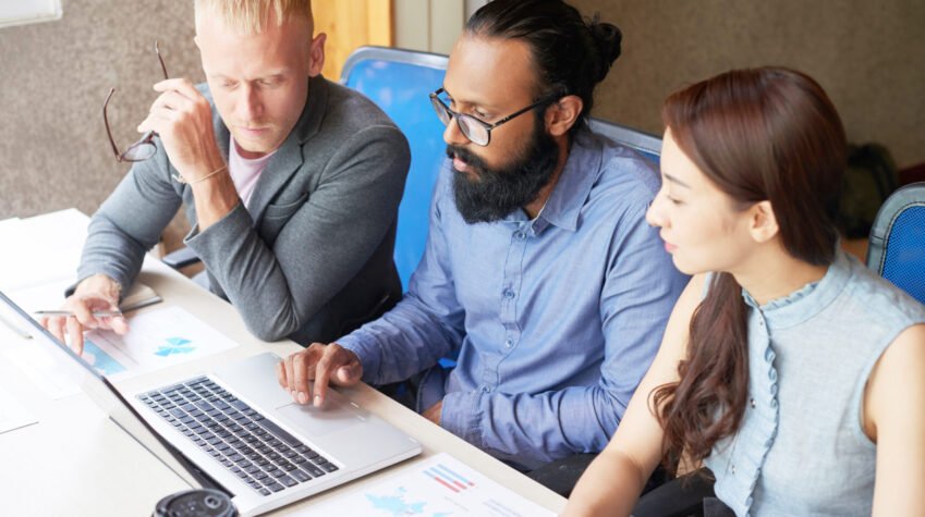 Business people sitting at office and developing new project with laptop