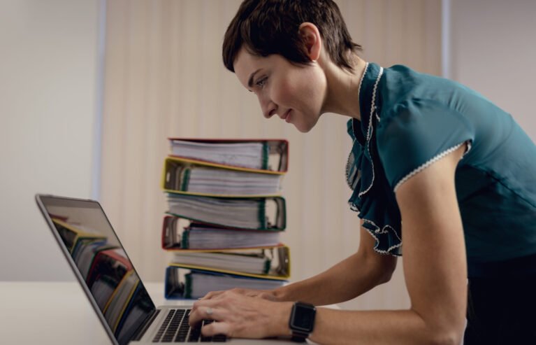 Beautiful businesswoman working over laptop in office