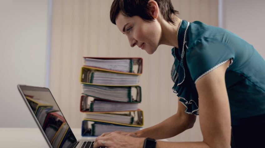 Beautiful businesswoman working over laptop in office